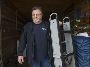 Glen Cook, owner of Glen's Moving, is pictured on April 4, 2018, as he moves office furniture out of an office building.