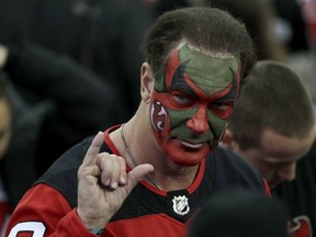 Patrick Warburton, the actor who played David Puddy on "Seinfeld" and wore makeup supporting the New Jersey Devils during an episode of the show, gestures at the end of Game 4 of an NHL first-round hockey playoff series between the Devils and the Tampa Bay Lightning, Wednesday, April 18, 2018, in Newark, N.J.