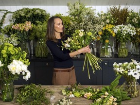 In this photo taken on Thursday, March 29, 2018, florist Philippa Craddock, poses for a photo, in her studio, in London. Britain's Prince Harry and Meghan Markle have chosen a self-taught London floral designer for their nuptials. The couple said Sunday, April 1, 2018 that Philippa Craddock will create the church flower arrangements for the May 19 wedding at St. George's Chapel in Windsor.