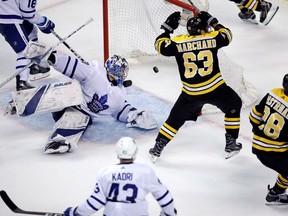 Toronto Maple Leafs goaltender Frederik Andersen looks back as the puck bounces to the back of the net on a goal by Boston Bruins right wing David Pastrnak (88) during the third period of Game 7 of an NHL hockey first-round playoff series in Boston, April 25, 2018. At centre is Bruins left wing Brad Marchand (63). Boston beats Leafs 7-4.