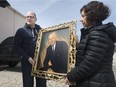 Mayor Drew Dilkens receives a portrait of former mayor Wilfred John Wheelton, from his daughter, Mary Wheelton, Monday, April 2, 2018.