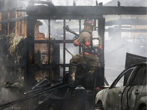 Essex firefighters battle a garage fire on Charles Street in McGregor on Tuesday, April 3, 2018.