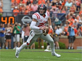 FILE - In this Oct. 7, 2017, file photo, Mississippi quarterback Shea Patterson (20) scrambles with the ball during the first half of an NCAA college football game against Auburn, in Auburn, Ala. Jim Harbaugh will lead Michigan through one more spring practice Tuesday, likely not knowing if Shea Patterson will be able to do more than practice in 2018. Two days later, most of the Wolverines are traveling to Paris to see some sights. By the time the Wolverines return from the trip, they hope to know if the NCAA will give Patterson a waiver to play instead of sitting out the season after transferring from Ole Miss.