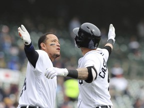 Detroit Tigers' Nicholas Castellanos is congratulated by Miguel Cabrera after they both scored on Castellanos' two-run home run during the third inning of a baseball game against the Kansas City Royals, Saturday, April 21, 2018, in Detroit.