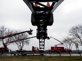 In this Tuesday, April 10, 2018 photo, contractors put the finishing touches on a million-dollar archway welcoming visitors to Frankenmuth on M-83 south of Bronner's Christmas Wonderland in Frankenmuth, Mich. The project is slated to be completed and the stretch of road reopened within the week.