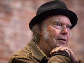 Canadian musician Neil Young speaks during a news conference in Vancouver, B.C., on Nov. 23, 2015. Young is joining his legendary backing band Crazy Horse for a pair of special performances.