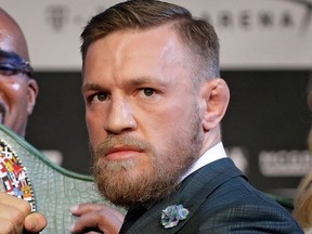 FILE - In this Aug. 23, 2017, file photo, Ultimate Fighting star Conor McGregor poses during a news conference in Las Vegas. McGregor is facing criminal charges in the wake of a backstage melee he allegedly instigated that has forced the removal of three fights from UFC's biggest card of the year. Video footage appears to show the promotion's most bankable star throwing a hand truck at a bus full of fighters after a Thursday, April 5, 2018, news conference for UFC 223 at Brooklyn's Barclays Center.
