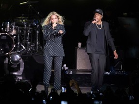 FILE - In this Nov. 4, 2016 file photo, Beyonce, center, and Jay-Z perform during a Democratic presidential candidate Hillary Clinton campaign rally in Cleveland. Beyonce performed a 2-hour set at Coachella, Saturday, April 14, 2018, paying tribute to the marching bands, the dance troupes and step teams at historically black colleges and universities. Jay-Z also came out for a collaboration.