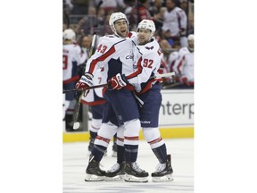 Washington Capitals' Tom Wilson, left, celebrates his goal against the Columbus Blue Jackets with teammate Evgeny Kuznetsov, of Russia, during Game 4 of an NHL first-round hockey playoff series Thursday, April 19, 2018, in Columbus, Ohio.