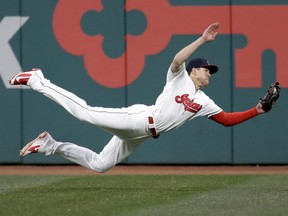 Cleveland Indians' Bradley Zimmer dives for a ball hit by Detroit Tigers' Dixon Machado during the seventh inning of a baseball game Thursday, April 12, 2018, in Cleveland. Machado was out on the play.