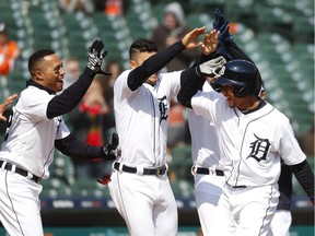 Detroit Tigers' Dixon Machado, right, celebrates his walk off solo home run in the ninth inning of a baseball game against the Baltimore Orioles in Detroit on April 18, 2018. Detroit won 6-5.