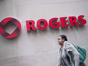 A pedestrian walks past the Rogers Building in Toronto on Tuesday, April 22, 2014. Rogers Communications Inc. says it expects to test new high-speed 5G wireless networks in Toronto, Ottawa and other select cities over the next year. THE CANADIAN PRESS/Darren Calabrese