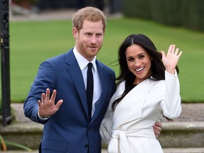 FILE - In this Nov. 27, 2017 file photo, engaged couple Britain's Prince Harry, left, and Meghan Markle pose for the media at Kensington Palace in London. The royal nuptials will take place on Saturday, May 19.