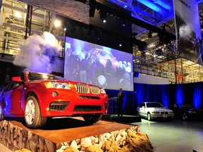 FILE- In this Jan. 12, 2012, file photo A BMW X 3, is driven out onto a stage area in Spartanburg, S.C. If a trade spat between the U.S. and China escalates and both countries raise tariffs, American automakers won't suffer that much. But German luxury automakers BMW and Mercedes will. BMW exports about 87,000 luxury SUVs from a factory near Spartanburg, S.C.