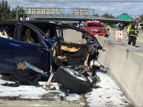 FILE- In this Friday, March 23, 2018, file photo provided by KTVU, emergency personnel work a the scene where a Tesla electric SUV crashed into a barrier on U.S. Highway 101 in Mountain View, Calif.  The National Transportation Safety Board is "unhappy" about Tesla's decision to release information in a fatal crash investigation involving its Autopilot system. A vehicle using the semi-autonomous system crashed into a concrete lane divider in California last week, killing the driver. (KTVU via AP, File) ORG XMIT: NYBZ125