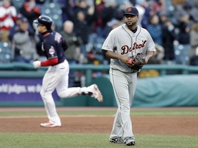 Detroit Tigers starting pitcher Francisco Liriano, right, waits for Cleveland Indians' Bradley Zimmer to run the bases after Zimmer hit a two-run home run in the fifth inning of a baseball game, Monday, April 9, 2018, in Cleveland. Indians' Yan Gomes also scored on the play.