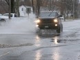 A pick-up truck makes a splash on County Road 50 in Essex on April 15, 2018.