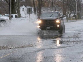 A pick-up truck makes a splash on County Road 50 in Essex on April 15, 2018.