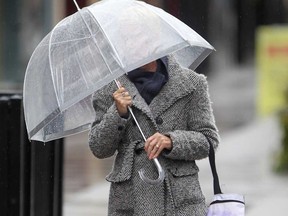 A pedestrian with an umbrella in downtown Windsor in October 2012.