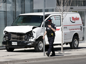 A police officer walks past a van used in a deadly attack on pedestrians in Toronto on April 23, 2018.