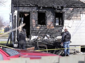Fire investigators examine the aftermath of an early morning blaze at 605 Vimy Ave. in Windsor on April 8, 2018.