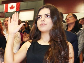 Marimar Shabo, 17, takes the oath of Canadian citizenship during a ceremony on May 9, 2018, at Catholic Central High School.