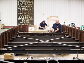 Wood craftsman Serge Legare, top, and metal fabricator Ray Ford work on Windsor's Streetcar 351 at RM Auto Restoration in Blenheim on May 15, 2018.  Specialists at RM Auto Restoration are detailing every inch of the historic streetcar. An original route scroll, shown on back wall, was found inside the walls of Streetcar No. 351.