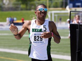 Herman Green Griffins William McBride crosses the finish line to win the senior boys' 800 metres on Thursday at the WECSSAA track and field championships at University of Windsor Stadium.