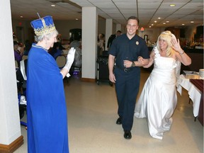 Windsor, Ontairo Royal Wedding couple Carlton Ylinen and Linda Hill, right, wave to Queen Evelyn Durocher, left, during Old Bats with Red Hats Royal Wedding event at Serbian Centre Thursday May 17, 2018. Four Windsor firefighters were invited as special guests.