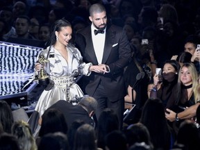 Rihanna, left, is escorted by presenter Drake after she accepted the Michael Jackson Video Vanguard Award at the MTV Video Music Awards at Madison Square Garden on Sunday, Aug. 28, 2016, in New York.(Photo by Chris Pizzello/Invision/AP) ORG XMIT: NYAH275
