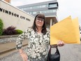 Caroline Taylor holds a complaint for Windsor's integrity commissioner at Windsor's new city hall, shown behind,  on Tuesday May 22, 2018.