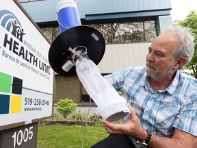 Mike Tudor of Windsor Essex County Health Unit with surveillance trap aimed at capturing species of Culex mosquitoes on Tuesday May 22, 2018.