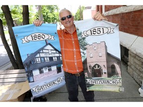Sandwich Towne volunteer Ron Morency hung banners on Mill Street.