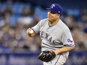 Texas Rangers starting pitcher Bartolo Colon reacts after catching a sharply hit comebacker to the mound from Toronto Blue Jays Kevin Pillar during sixth inning American League baseball action in Toronto on April 28, 2018.