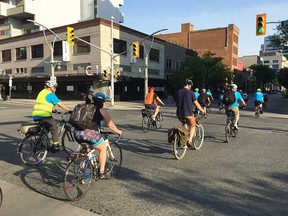Dozens of participants in Bike Windsor Essex's Bike to Work Day travel north on Ouellette Avenue in downtown Windsor on the morning of May 28, 2018.