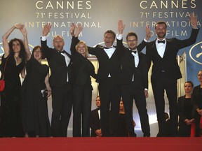 Producer Tanya Seghatchian, from left, actors Borys Szyc, Joanna Kulig, director Paweł Pawlikowski, producer Ewa Puszczynska and actor Tomasz Kot, far right, pose for photographers upon arrival at the premiere of the film 'Cold War' at the 71st international film festival, Cannes, southern France, Thursday, May 10, 2018.