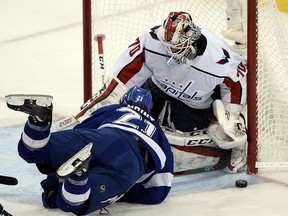 Tampa Bay Lightning centre Brayden Point, left, falls in front of Washington Capitals goaltender Braden Holtby during Game 7 of the Eastern Conference final Wednesday, May 23, 2018, in Tampa, Fla. (AP Photo/Jason Behnken)