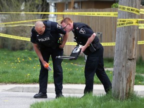 Windsor police officers investigate an incident in which an elderly male cyclist was struck by a transport truck on College Avenue near Elm Avenue on May 6, 2018.
