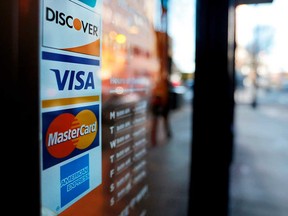 Credit card company logos on the door of a business in Atlanta, Georgia, in January 2018.