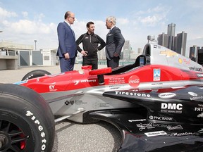 From left: Windsor Mayor Drew Dilkens, champion IndyCar driver Simon Pagenaud, and Detroit Grand Prix chairman Bud Denker confer behind a Lear IndyCar on Windsor's riverfront on May 2, 2018.
