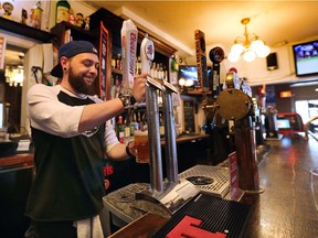 Jordan Tough co-owner of the Dominion House Tavern in Windsor, ON. pours a beer at the landmark west end establishment on Thursday, May 10, 2018. The DH will be celebrating its 140th anniversary on the May long weekend.