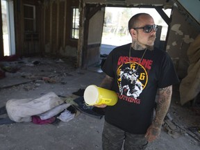 Andrew Steptoe, owner of a tattoo shop on Wyandotte Street East, stands in an adjacent burnt out building — the former le Chef restaurant — on Tuesday, May 8, 2018, where he routinely finds people using the area to do drugs.