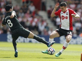 Manchester City's Ilkay Gundogan, left, and Southampton's Pierre-Emile Hojbjerg challenge for the ball during the English Premier League soccer match between Southampton and Manchester City at St Mary's Stadium in Southampton, Sunday, May 13, 2018.