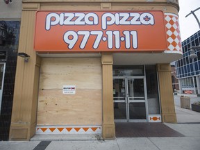 WINDSOR, ONT:. MAY 26, 2018 -- A boarded up window is shown at Pizza Pizza after an altercation let to a male, 22, being thrown through the window in the early morning, Saturday, May 26, 2018.