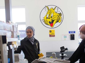 A cashier handles customers at a Giant Tiger location in Montreal, Que., in this 2010 file photo.