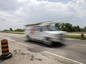 A vehicle drives over a patch of Highway 3 on May 31, 2018, after it was repaired for heaving during the extreme temperatures.