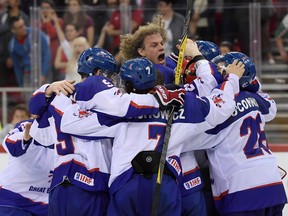 Members of the British national team celebrate their win over Hungary at the Division I, Group A world championships on April 28. The win guaranteed Britain a spot in the tournament's top flight in 2019.