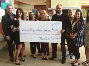 Windsor Regional Hospital's director of radiation oncology Jeff Richer, right, receives a $138,946 donation for the Windsor Regional Cancer Centre from Windsor Cancer Centre Foundation executive director Houida Kassel Thursday May 17, 2018.