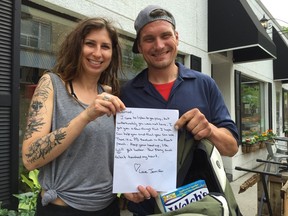 Kate Isley, left, and Jarrod Zavitz, hold a care package stuffed with food and a handwritten note from Jennifer from Amherstburg, who was moved after reading about the plight of the homeless Zavitz in The Star.