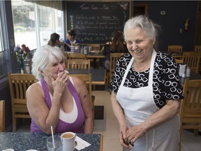 Anna Dragicevic, owner of Lad's Dairy Bar, talks with one of her two last customers, Karen Cook, left, on her last day of business on May 25, 2018.